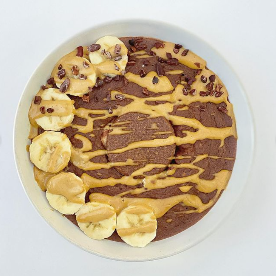 Chocolate Vanilla Cheesecake Baked Oats topped with banana and peanut butter